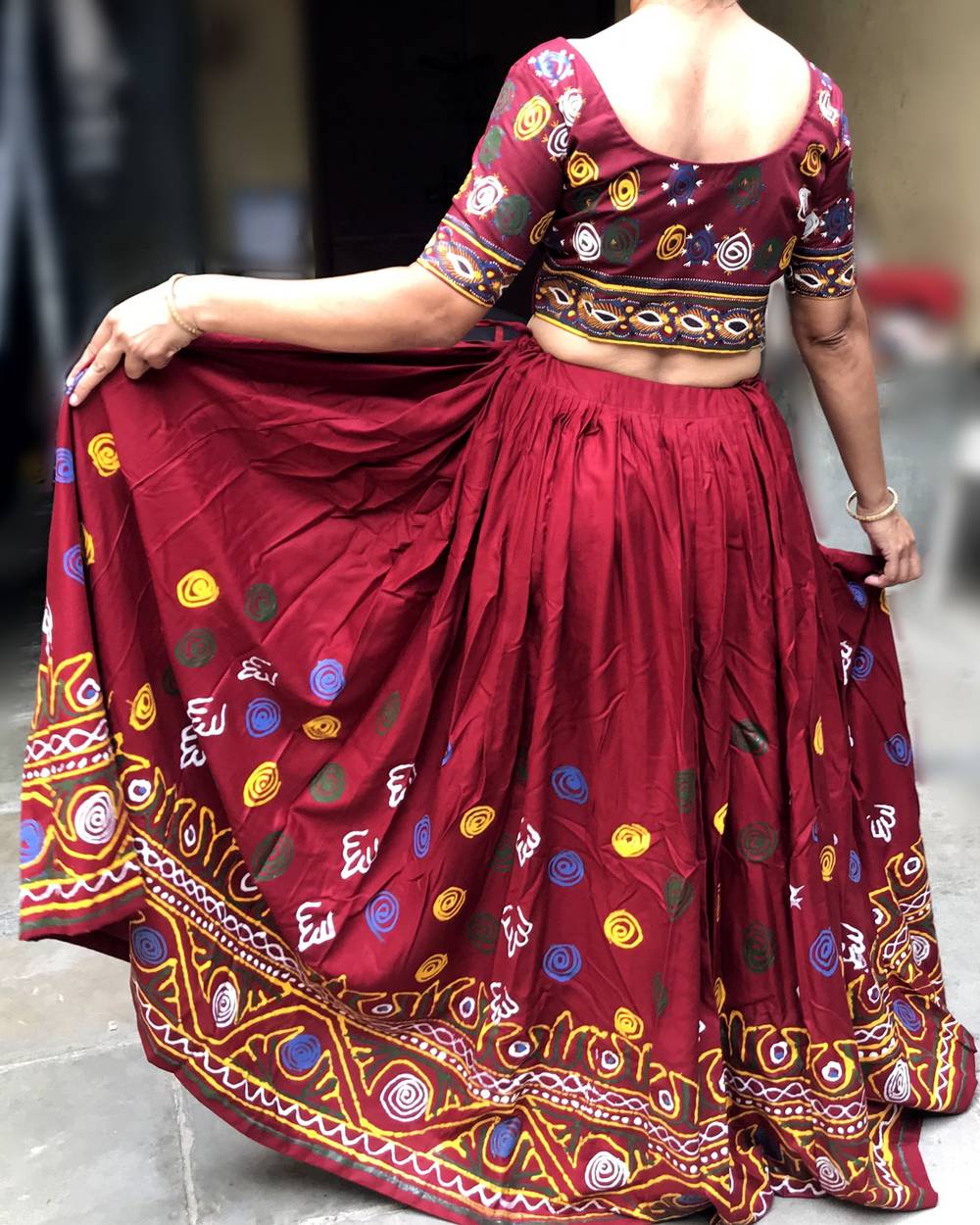 Woman in a maroon embroidered lehenga