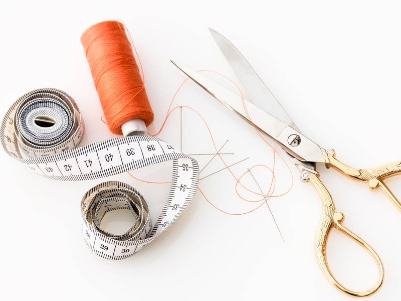 Measuring tape, thread and scissors